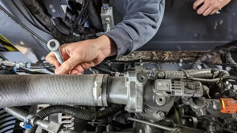 A mechanic inspecting a heavy equipment on a pre purchase inspection routine. 